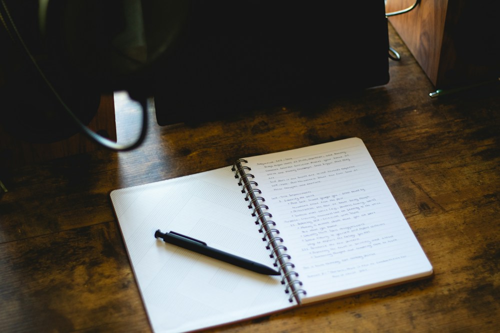 Notebook and project notes on a wooden desk